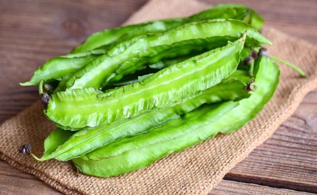 Fresh raw winged beans on burlap cloth, ready for cooking Fresh raw winged beans on burlap cloth, ready for cooking
